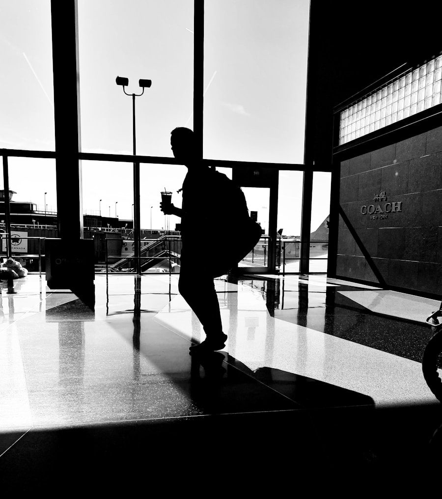 silhouette of man walking on sidewalk